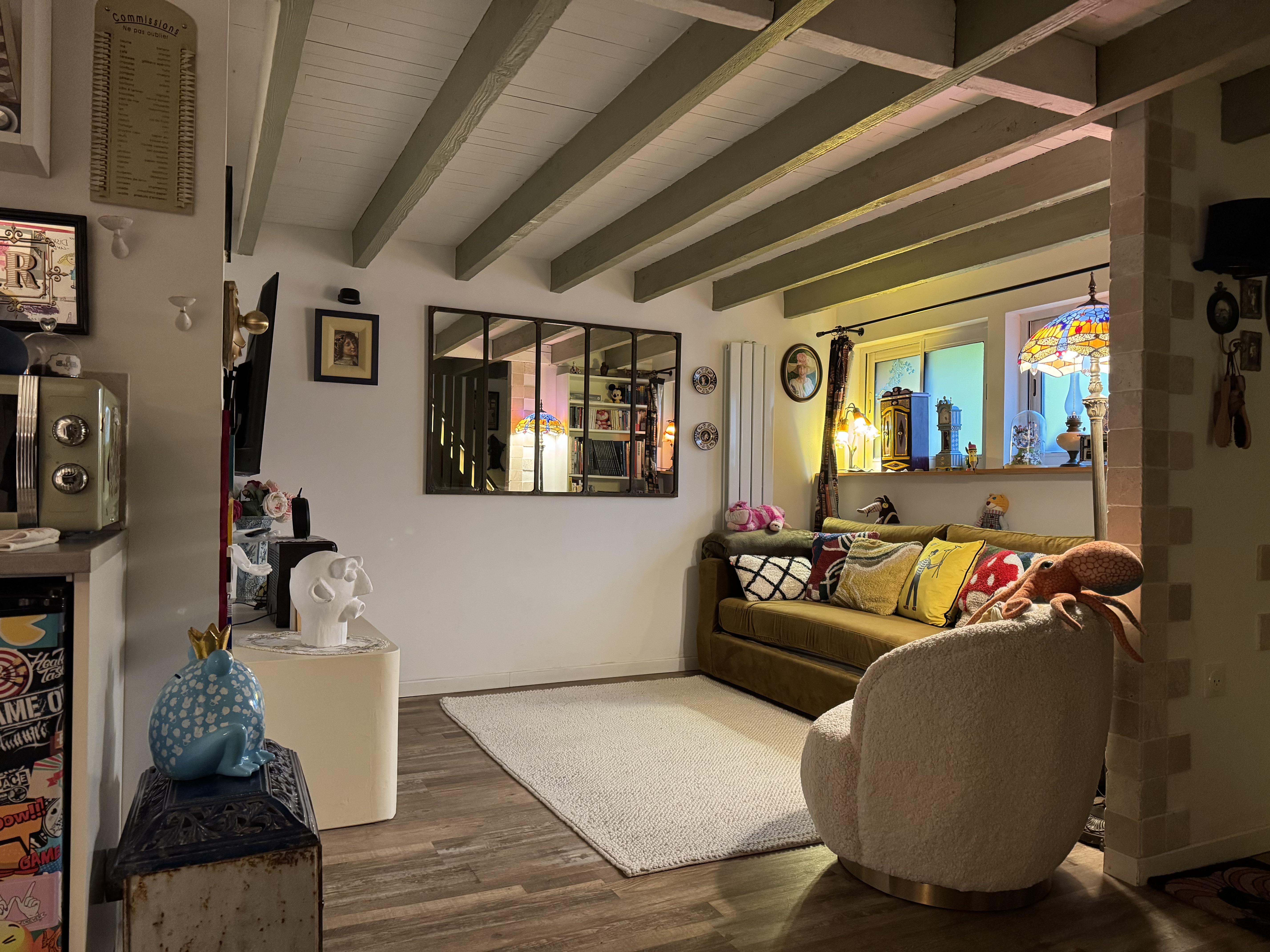 La Maison d'Alice — salon lumineux avec poutres apparentes, canapé cosy et décor féerique, chambre d'hôte Wonderland21